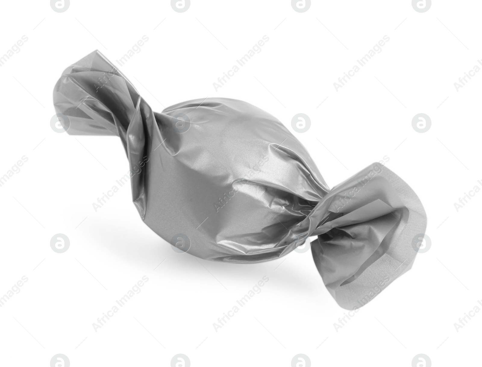 Photo of Tasty candy in silver wrapper isolated on white