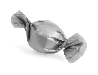 Tasty candy in silver wrapper isolated on white