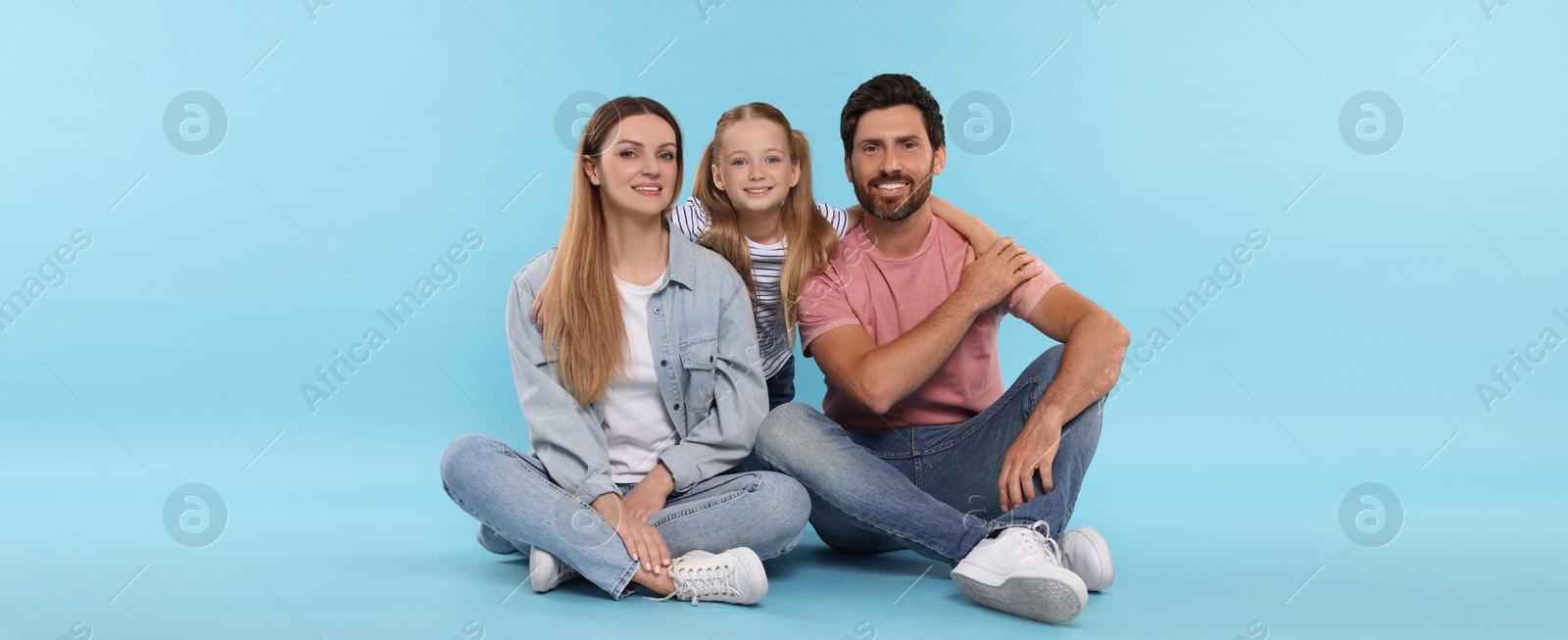 Image of Happy family with child on light blue background. Banner design