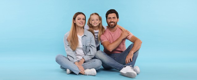 Happy family with child on light blue background. Banner design