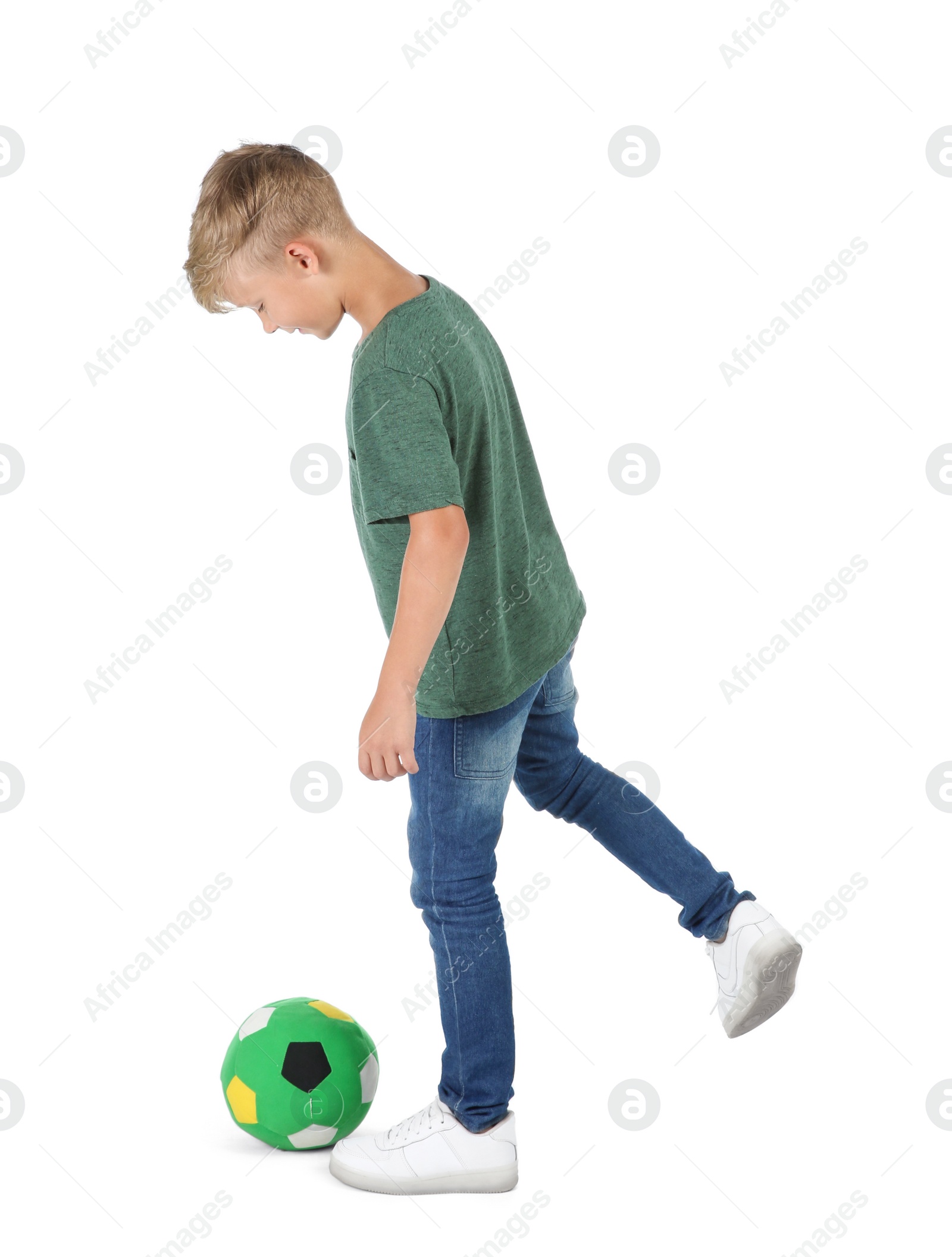 Photo of Little child playing with soccer ball on white background. Indoor entertainment