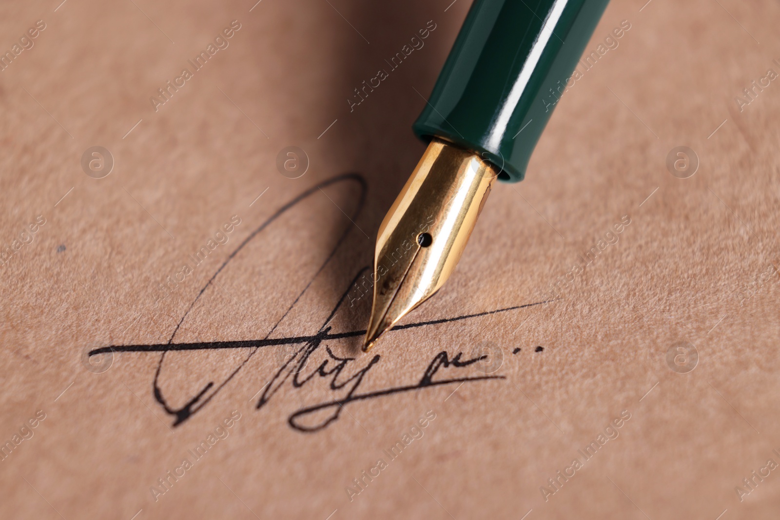 Photo of Signing on sheet of paper with fountain pen, closeup