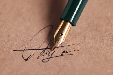 Photo of Signing on sheet of paper with fountain pen, closeup