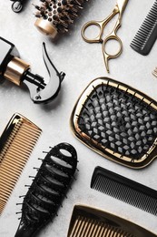 Hairdressing tools on light background, flat lay