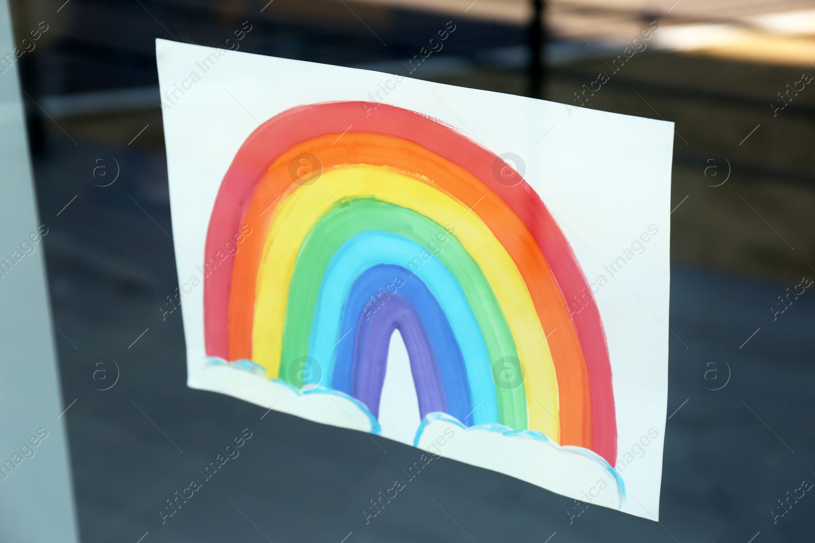 Photo of Picture of rainbow on window, view from outdoors. Stay at home concept