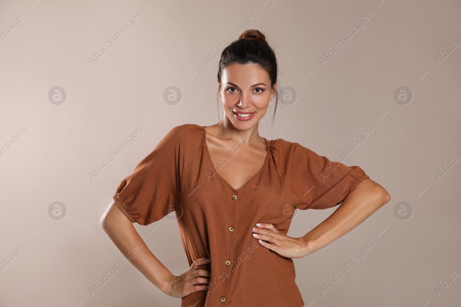 Photo of Portrait of beautiful woman on light brown background