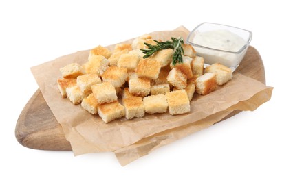 Delicious crispy croutons with rosemary and sauce on white background