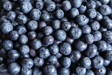 Photo of Fresh raw blueberries as background, top view