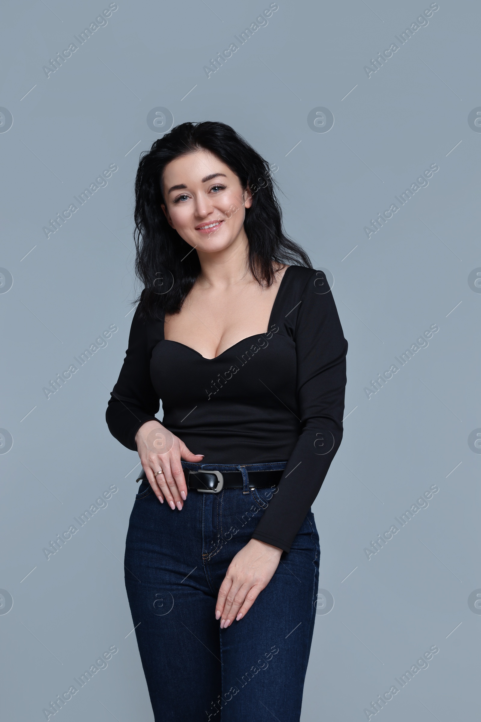Photo of Beautiful woman in casual outfit on grey background