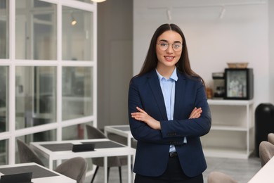 Happy real estate agent indoors. Space for text