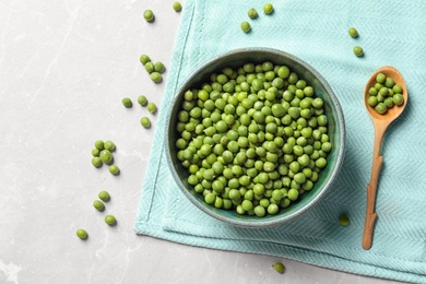 Flat lay composition with green peas on light background