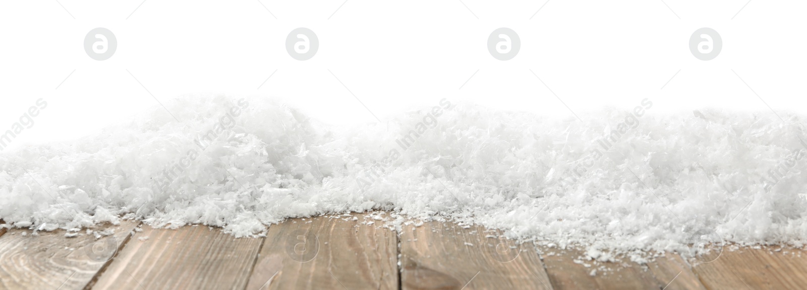 Photo of Snow on wooden surface against white background. Christmas season