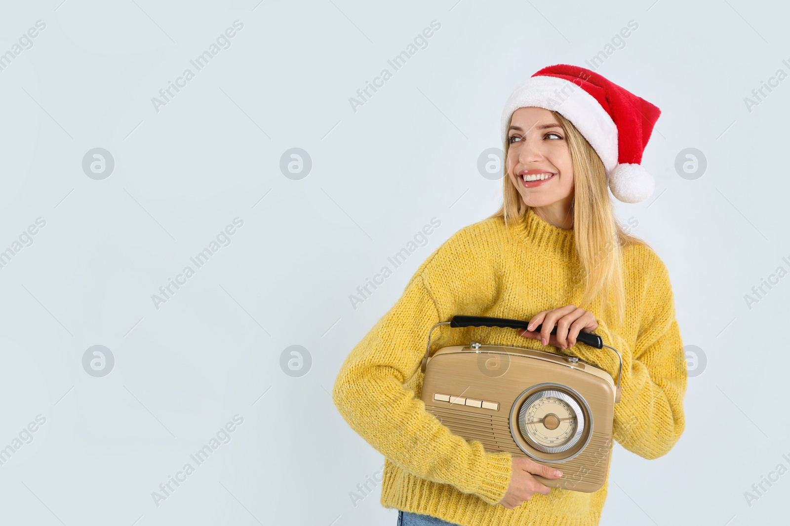 Photo of Happy woman with vintage radio on white background, space for text. Christmas music