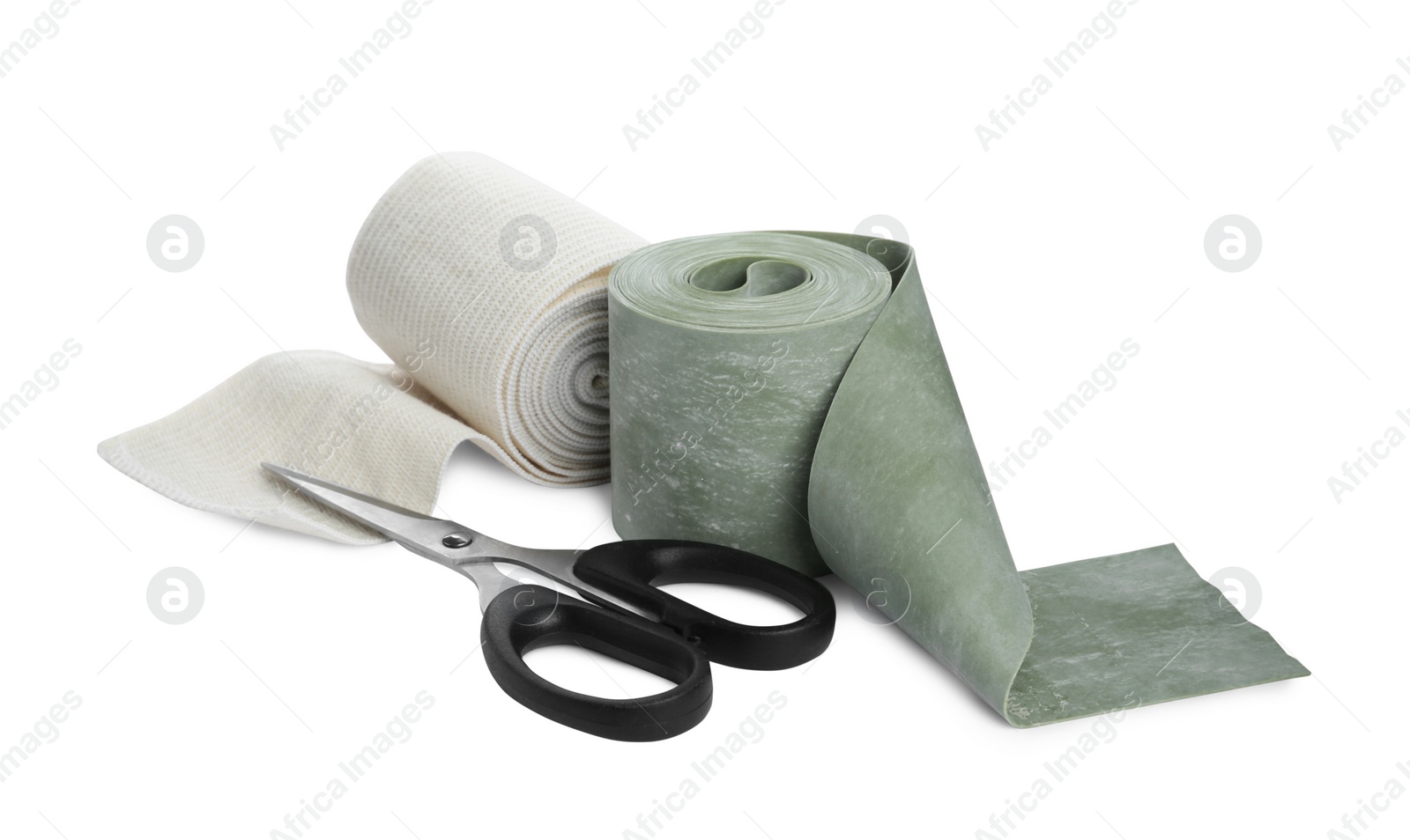 Photo of Medical bandage rolls and scissors on white background