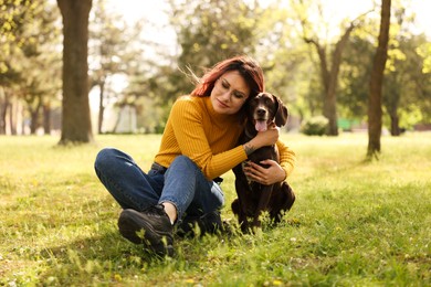 Woman with her cute German Shorthaired Pointer dog in park on spring day