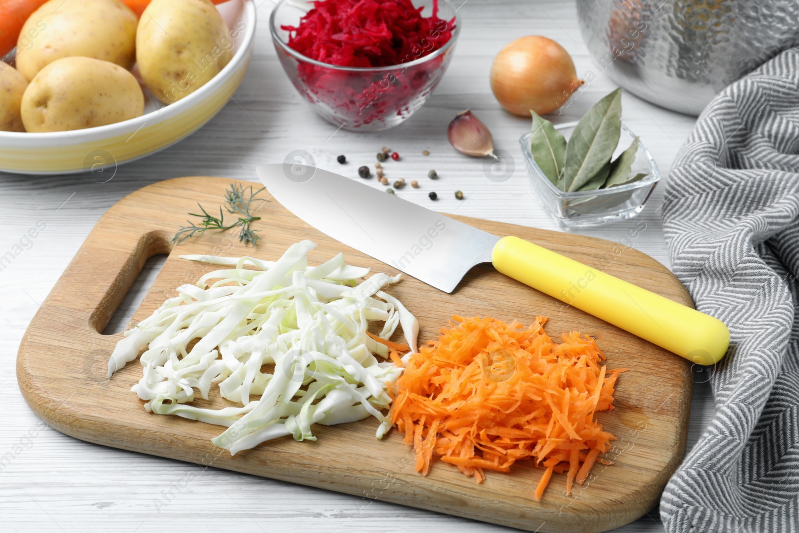 Photo of Fresh ingredients for borscht on white wooden table