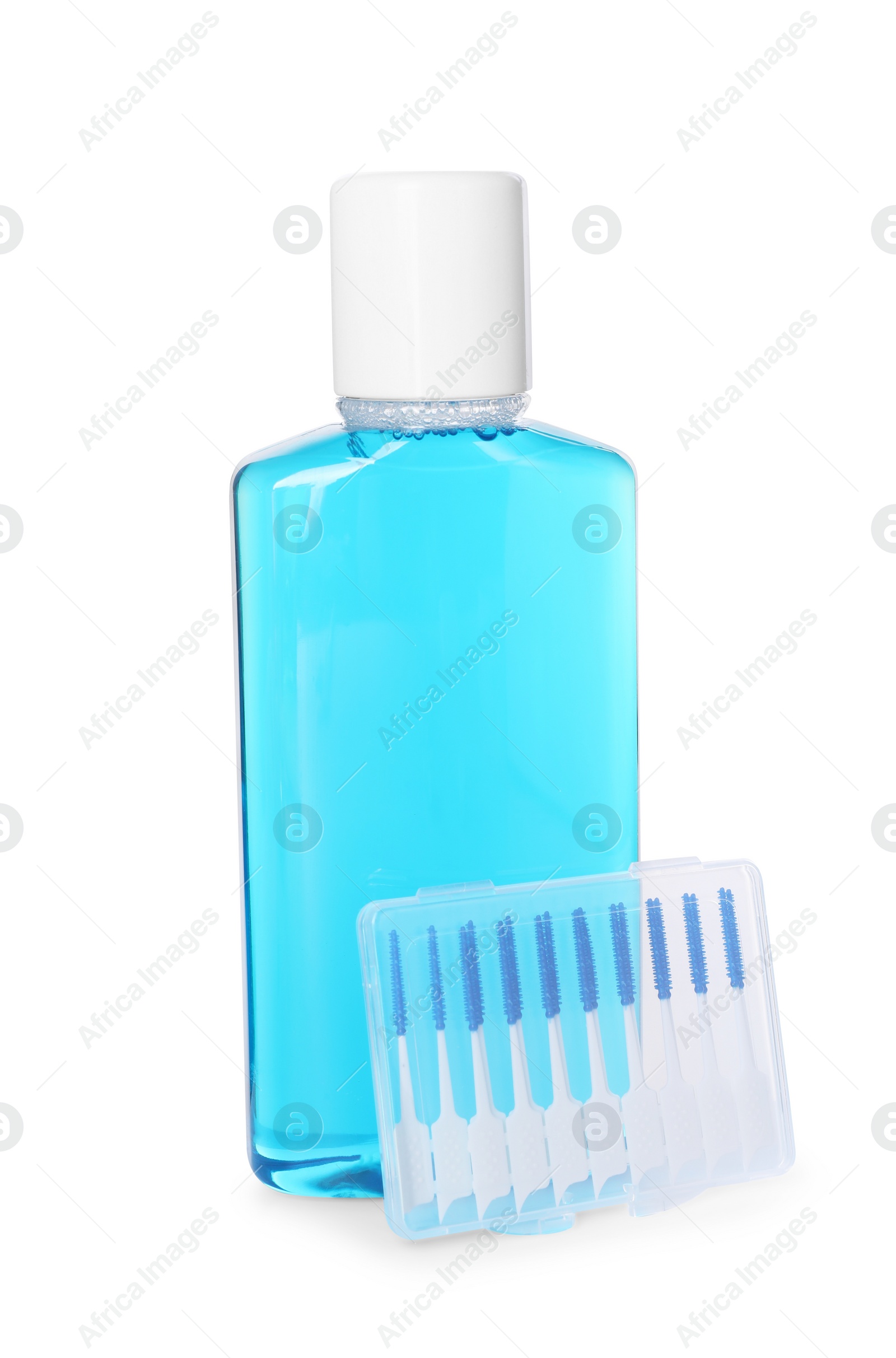 Photo of Bottle of mouthwash and interdental brushes isolated on white