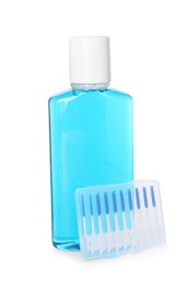 Photo of Bottle of mouthwash and interdental brushes isolated on white