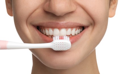 Woman brushing teeth on white background, closeup. Dental care