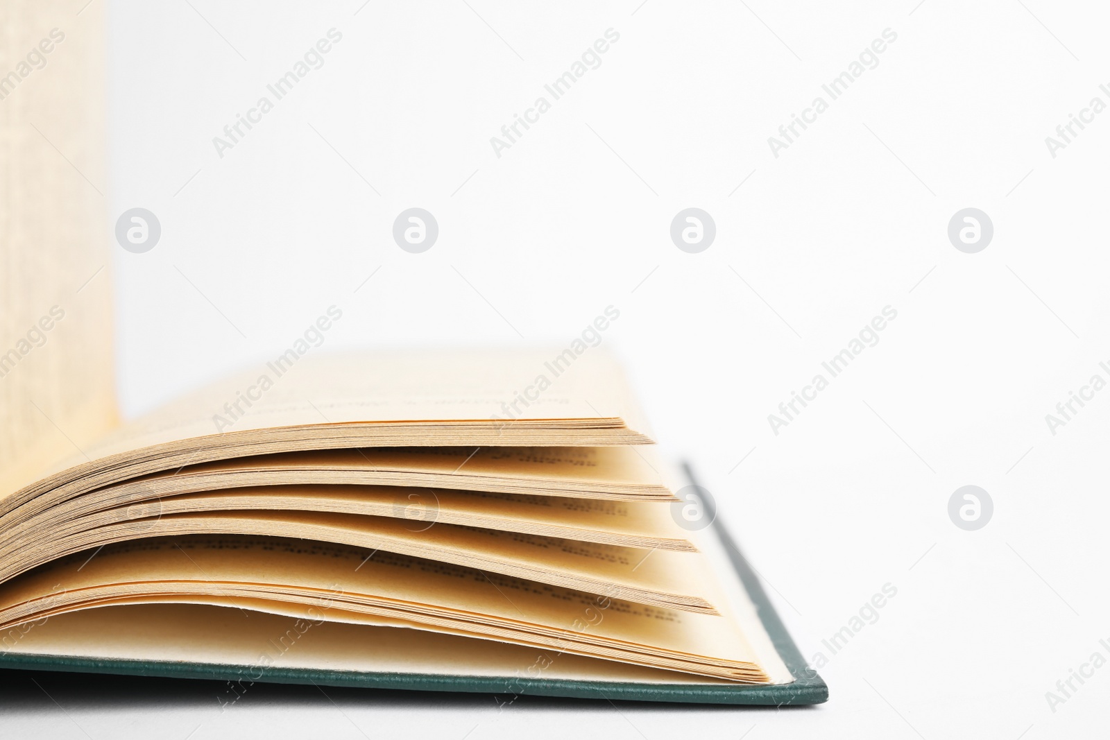 Photo of Closeup view of open book on white background