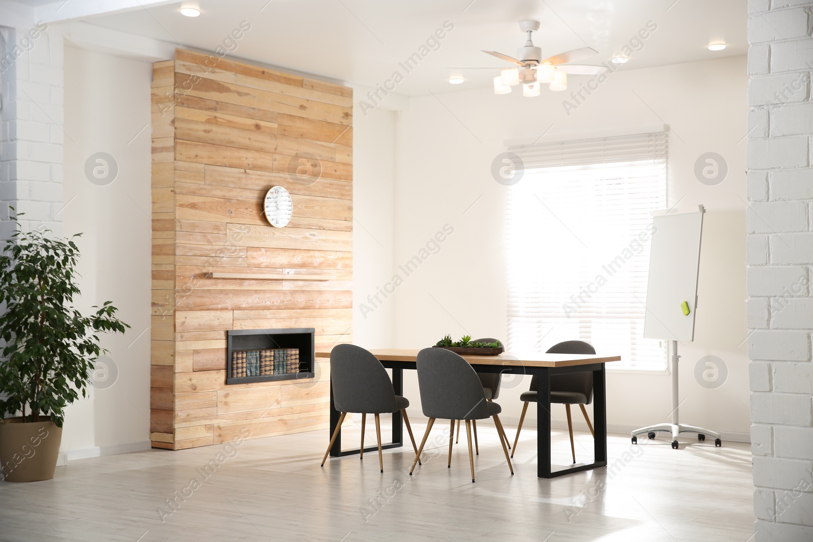 Photo of Modern meeting room interior with large table and chairs