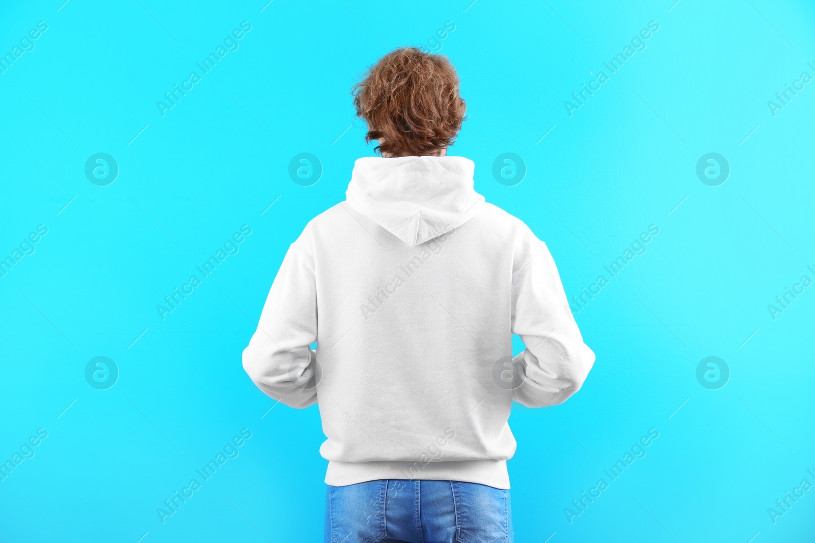 Photo of Man in hoodie sweater on color background. Space for design