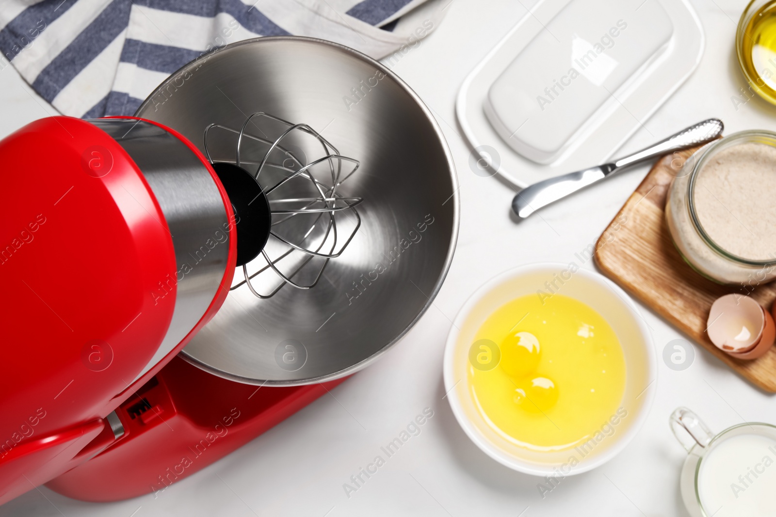 Photo of Modern red stand mixer and different ingredients on white table, flat lay