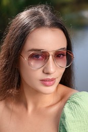 Beautiful woman in sunglasses outdoors on sunny day