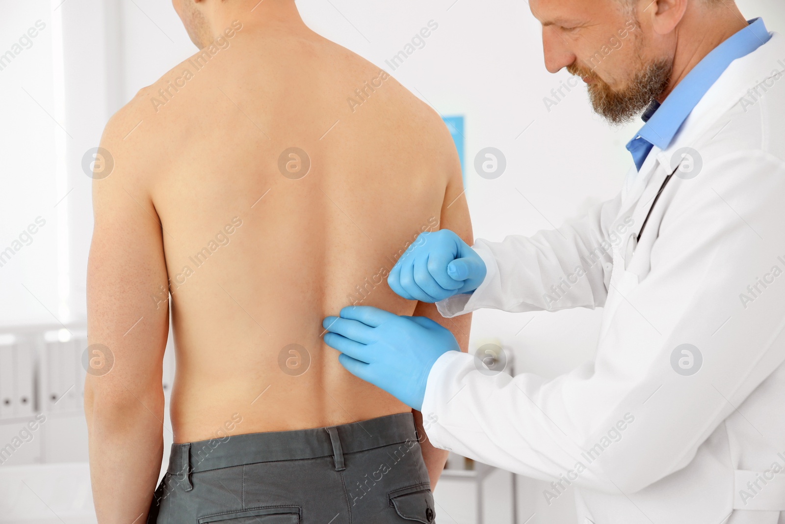 Photo of Urologist examining patient in hospital