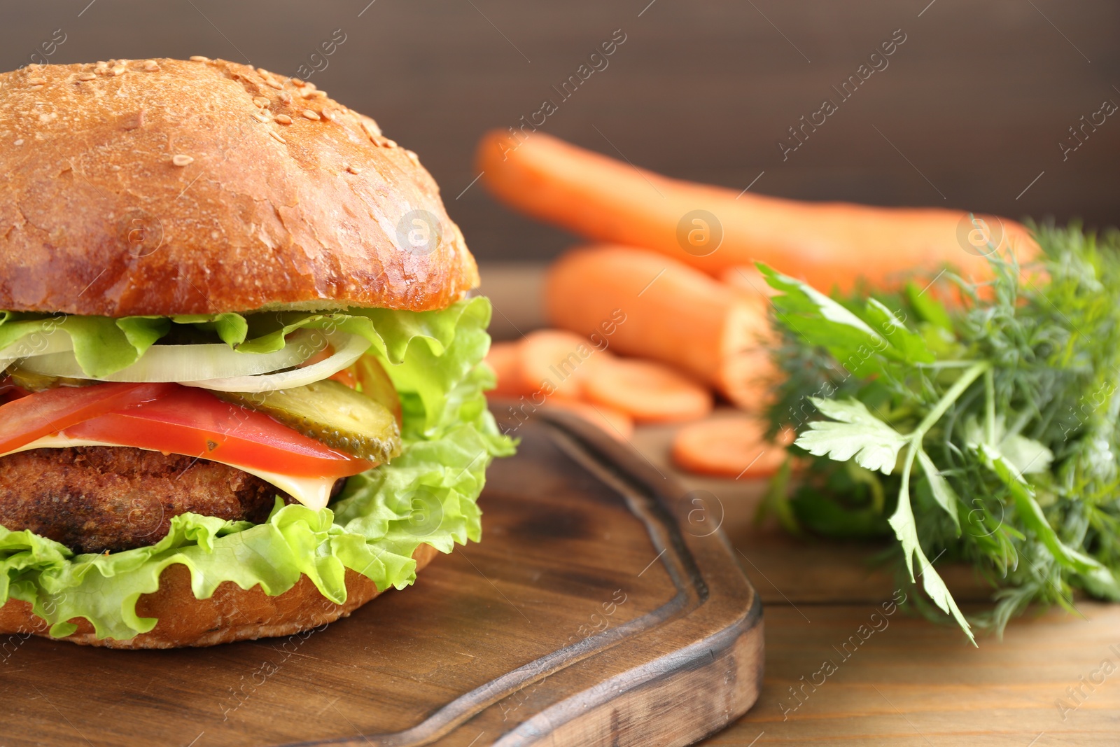 Photo of Delicious vegetarian burger served on wooden table, closeup