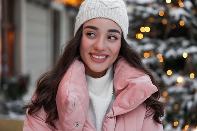 Portrait of smiling woman on city street in winter