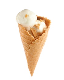 Waffle cone with ice cream, caramel and nuts on white background