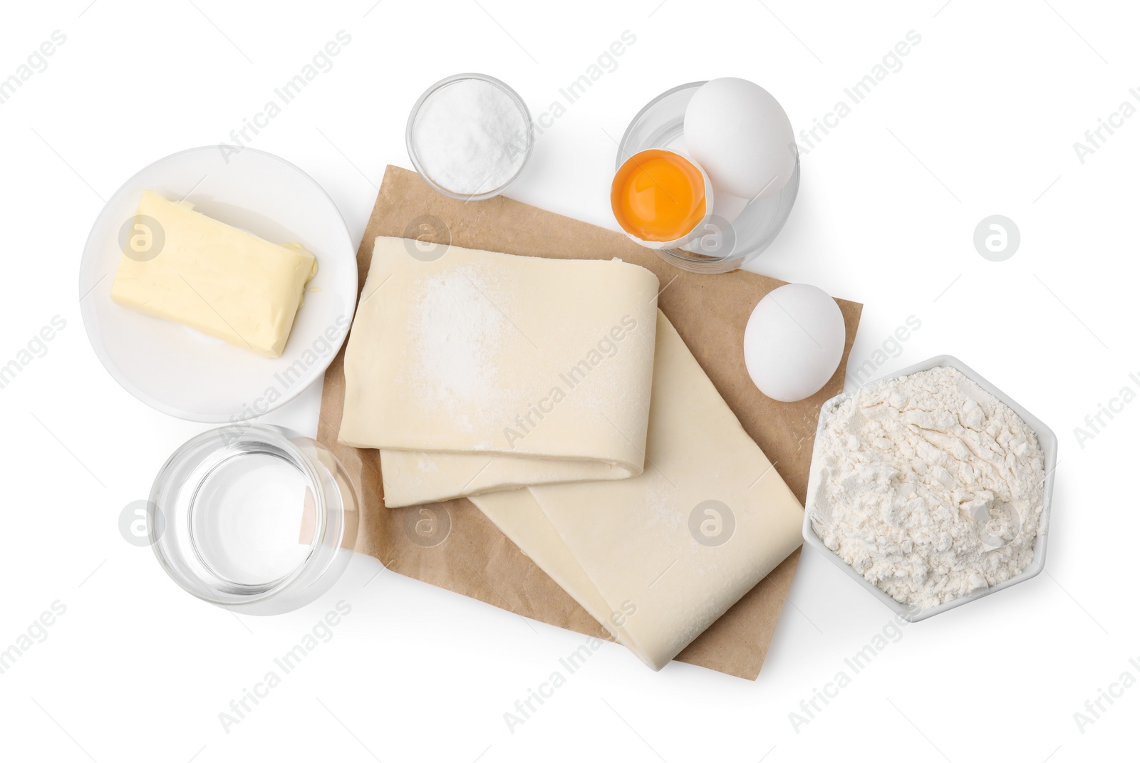 Photo of Raw puff pastry dough and ingredients isolated on white, top view