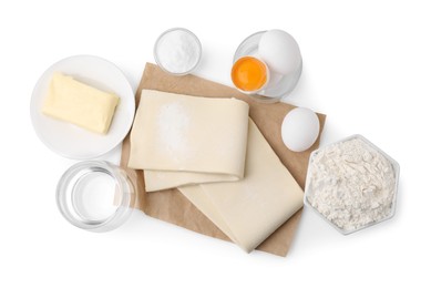 Photo of Raw puff pastry dough and ingredients isolated on white, top view