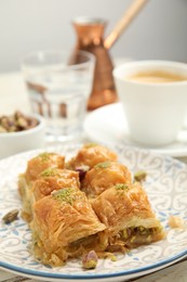 Photo of Delicious baklava with pistachios on plate, closeup