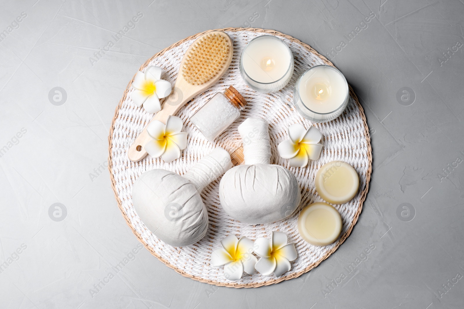 Photo of Spa bags, sea salt and scented candles on light gray background, top view