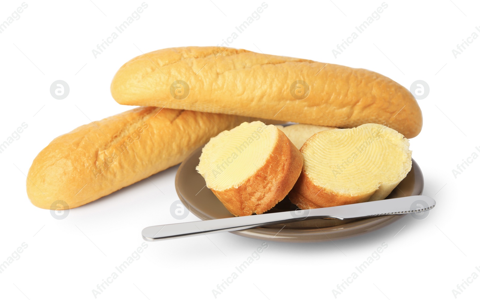 Photo of Whole and cut baguettes with fresh butter on white background