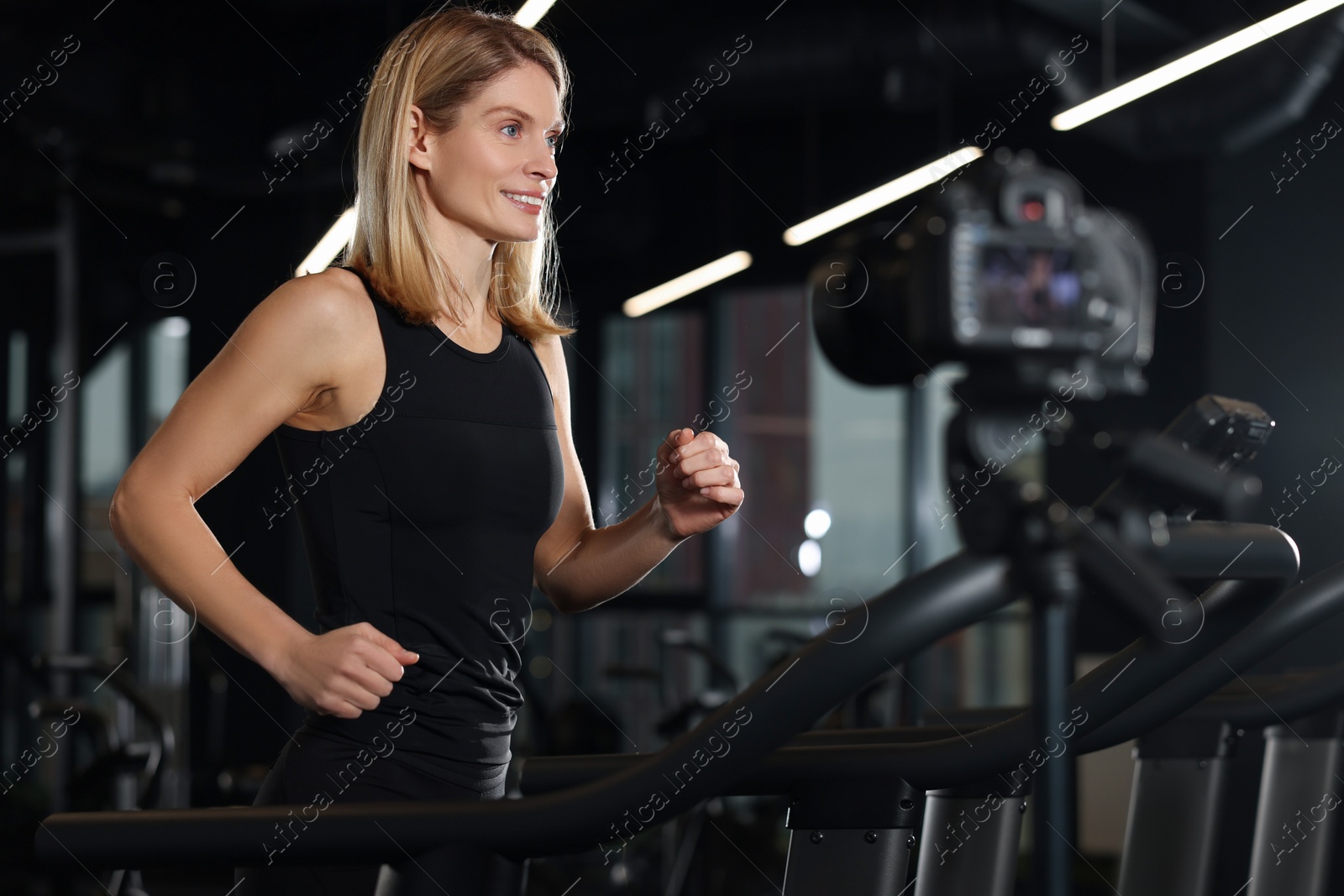 Photo of Fitness trainer recording online classes in gym