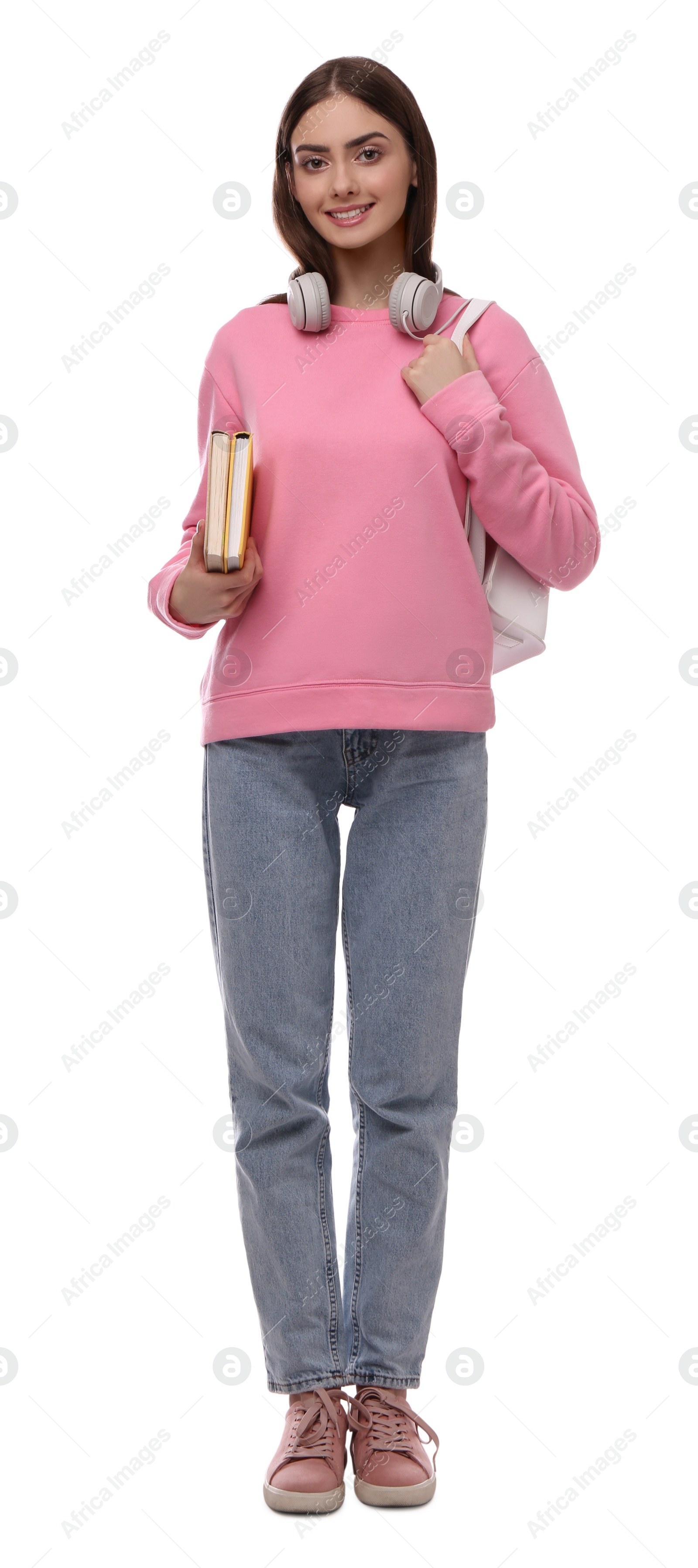 Photo of Teenage student with backpack, headphones and books on white background