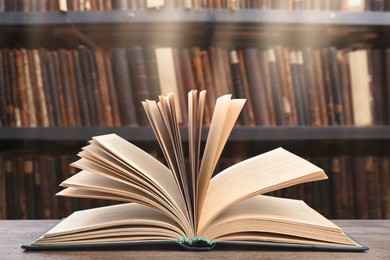 Image of Open book on wooden table in library