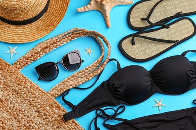 Photo of Flat lay composition with sunglasses and beach accessories on blue background