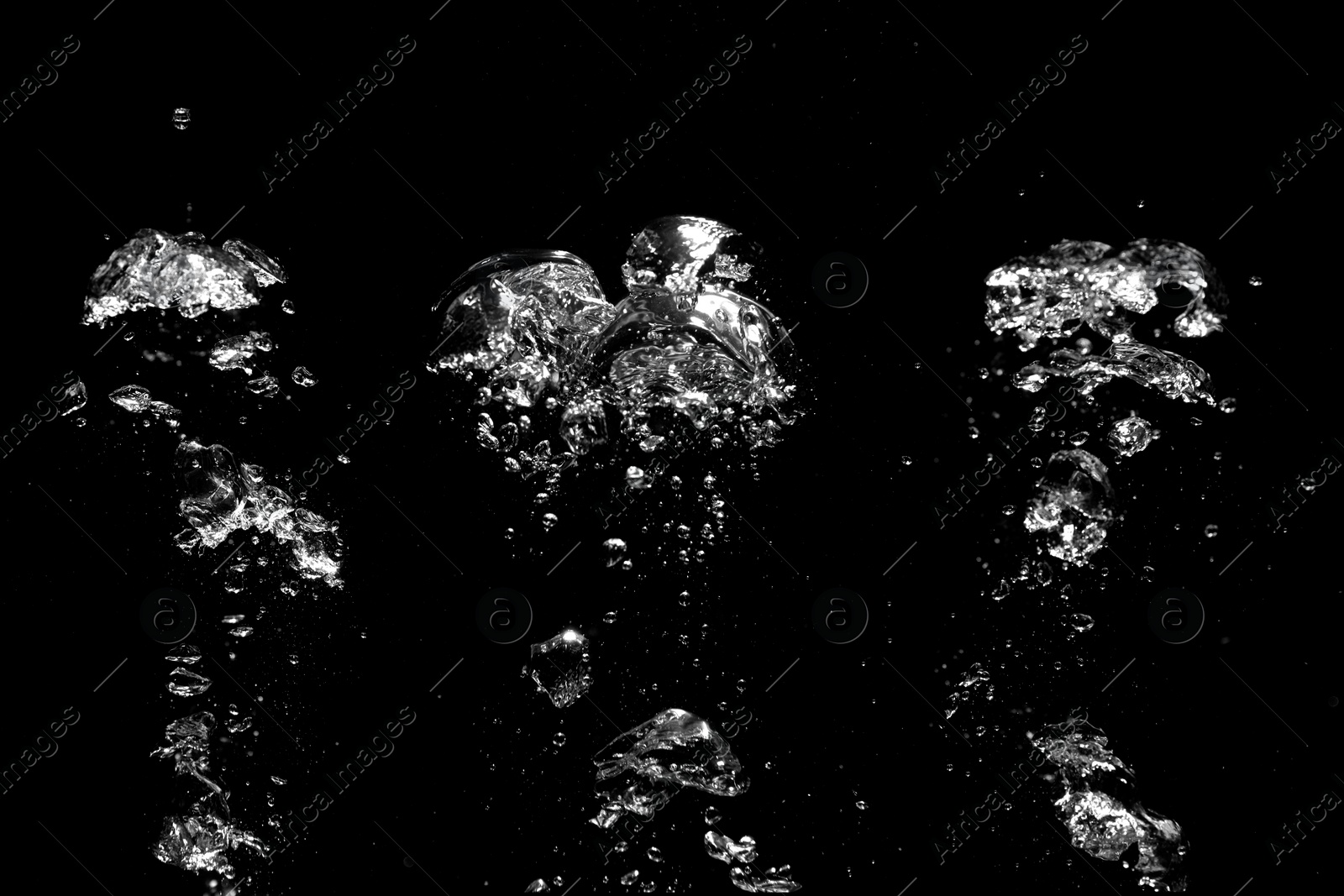 Image of Collage with air bubbles in water on black background