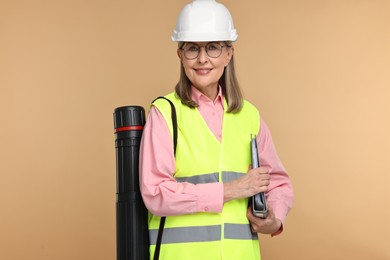Photo of Architect in hard hat with folder and tube on beige background