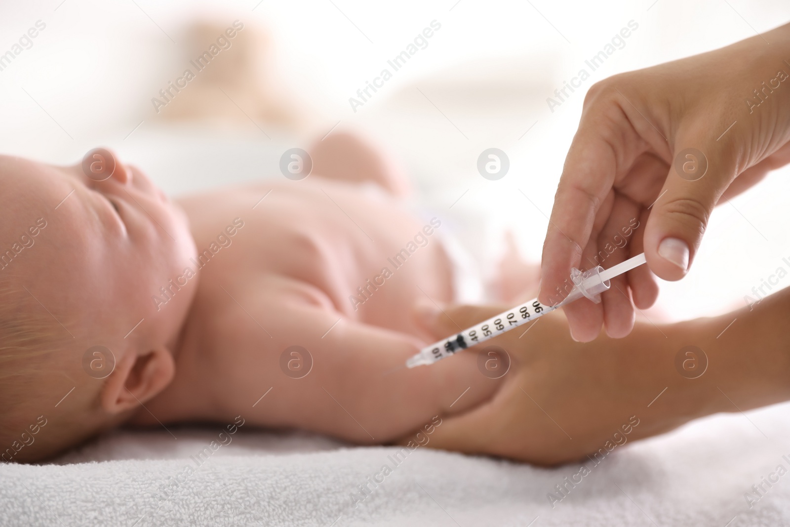 Photo of Doctor vaccinating cute baby, closeup. Health care