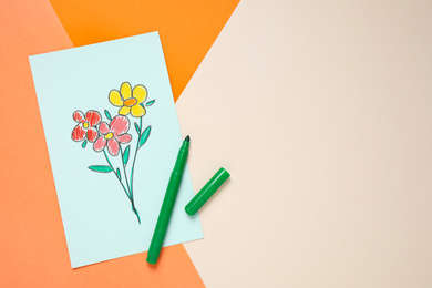 Top view of greeting card with drawn flowers and felt tip pen on color background, space for text. Happy mother's day