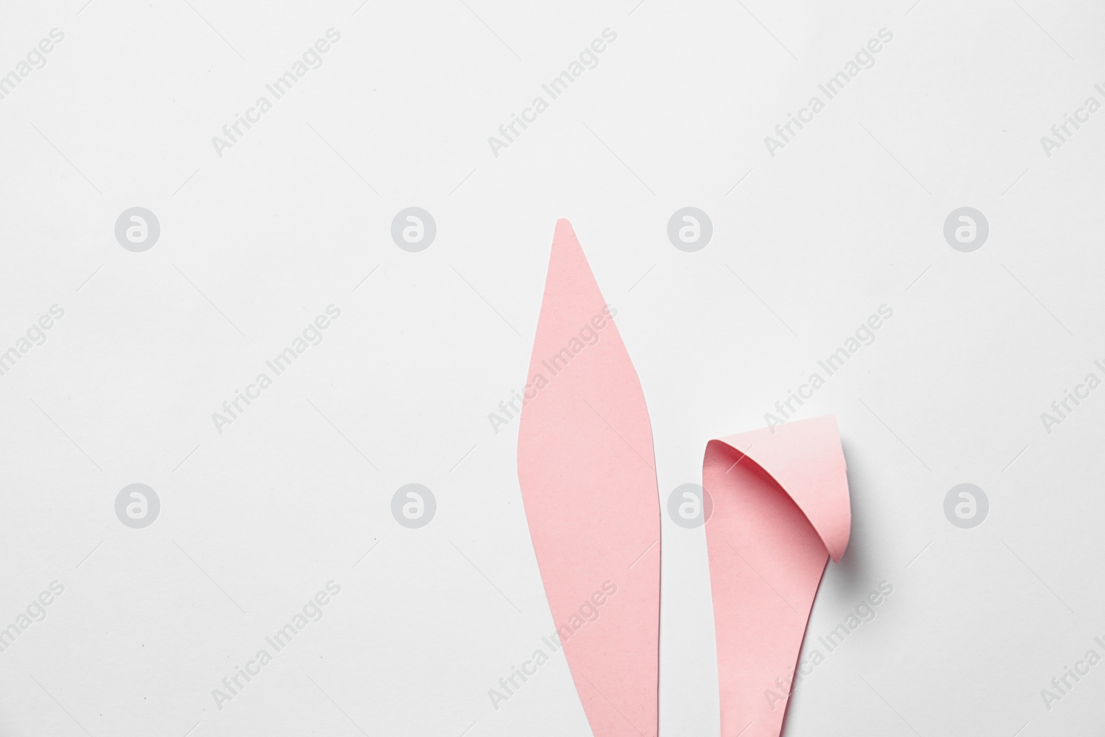 Photo of Funny Easter bunny ears on white background, top view