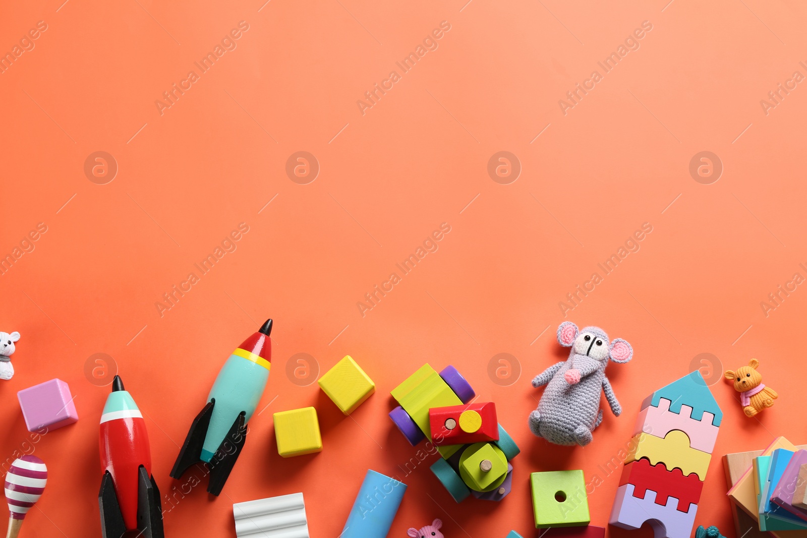 Photo of Different toys on orange background, flat lay. Space for text