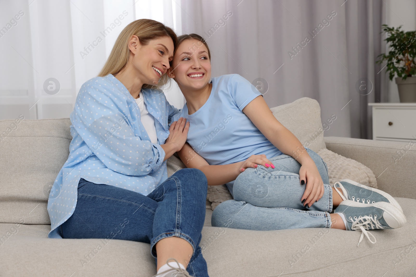 Photo of Happy mother with her teenager daughter spending time together at home