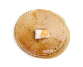 Tasty pancakes with butter and honey on white background, top view