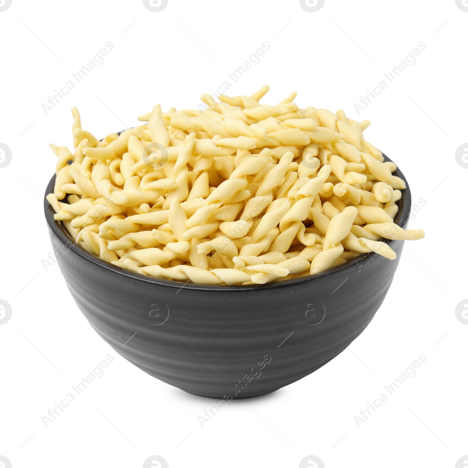 Photo of Uncooked trofie pasta in bowl isolated on white